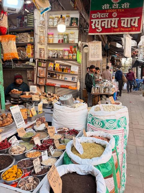       Vibrant street market scene with various goods and people.
  