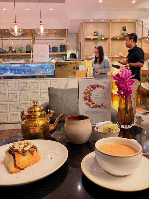       Close-up of a tea set with a decorative countertop.
  