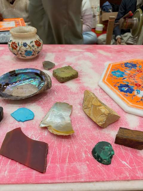       Array of decorative materials on a pink surface.
  