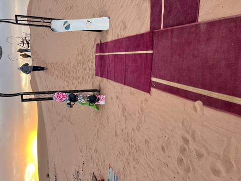 Sandboarding activity in the desert during sunrise.