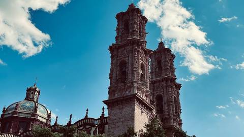       A cathedral with intricate architecture against a blue sky.
  