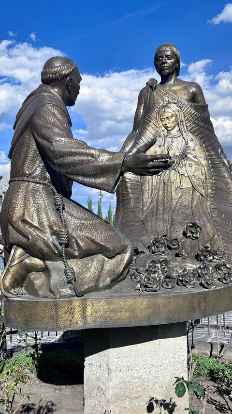       Statue depicting a figure with an intricate background.
  