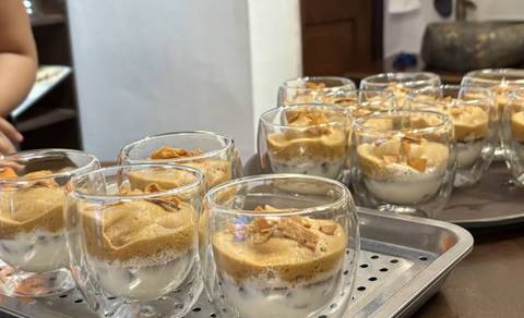       Close-up of dessert served in glass cups on a tray
  