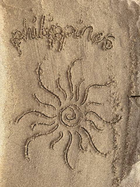 Sun symbol drawn in the sand