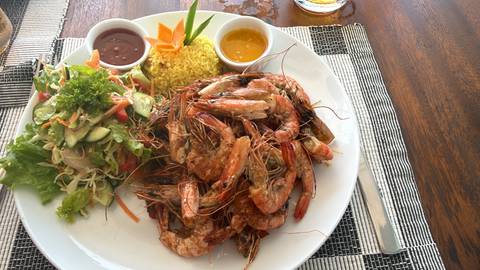 Platter of grilled prawns with rice and salad