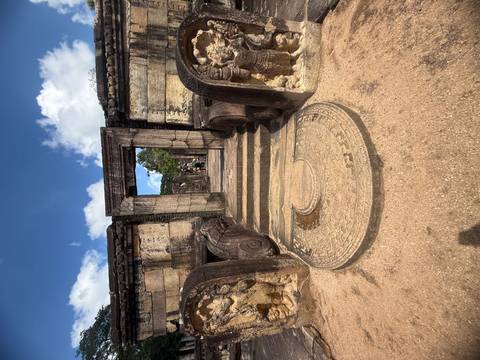Ruins of an ancient city with steps and carvings.