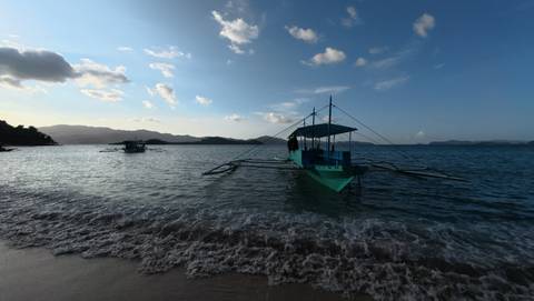 Traditional boat on the ocean at sunset.