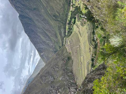       Terraced fields in a valley surrounded by mountains.
  
