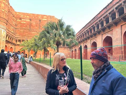 People in a courtyard of a historic structure.