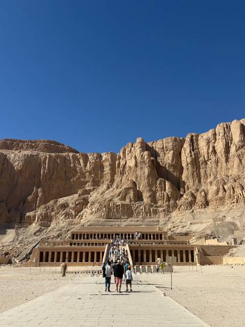 Rocky desert landscape under a clear blue sky.