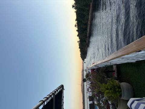 View from a cruise ship on a river at sunset.
