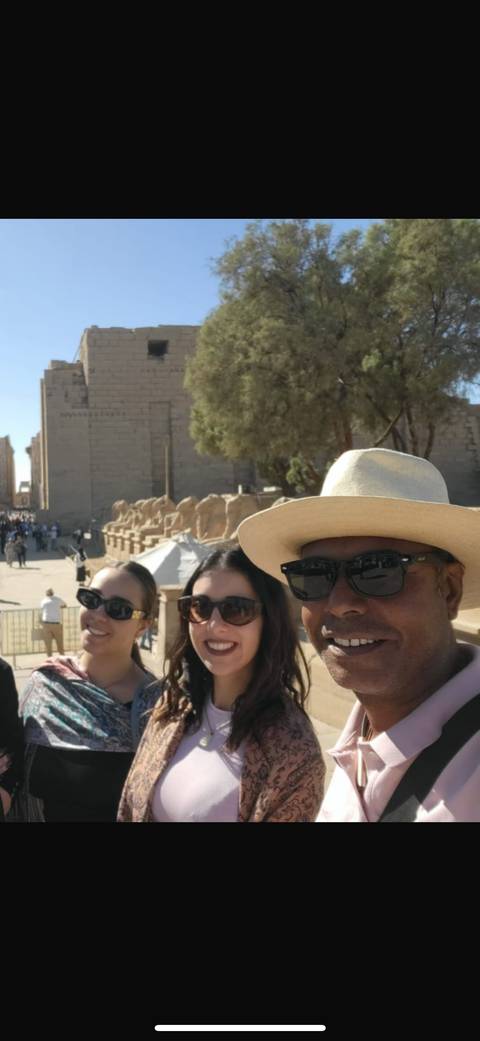      Selfie of a group of people at an ancient Egyptian site.
  