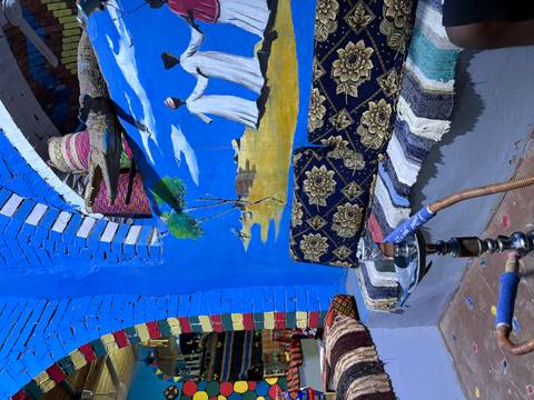 Colorful mural with traditional patterns and a shisha pipe.