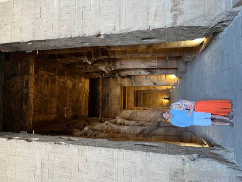 Couple posing inside ancient Egyptian temple.