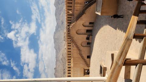      Historic fort with visitors walking around.
  