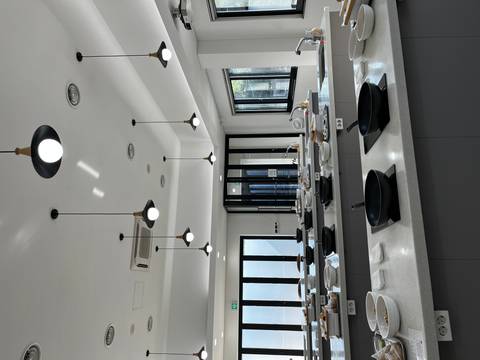       Modern kitchen interior with cooking stations and bright lighting.
  