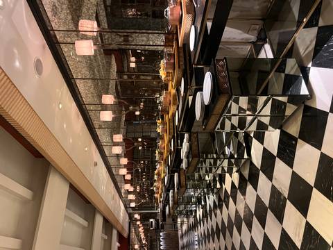 Buffet dining area with elegant setup and mirrored walls.