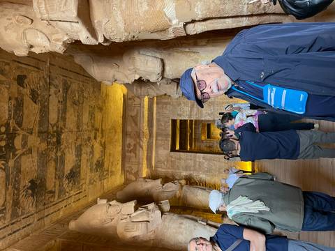       Interior of Abu Simbel with tourists and statues.
  