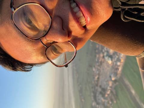       Close-up of a smiling young man in sunlight.
  