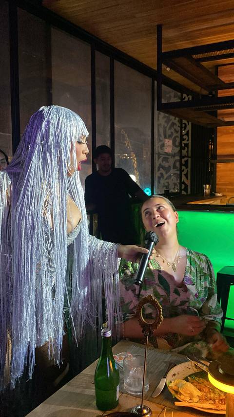 Indoor performance with an artist and a woman looking up in admiration.