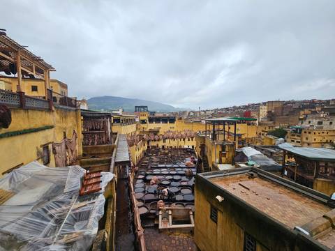       High angle overview of the leather tanning pits in Fes on a rainy day.
  