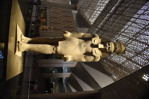       Illuminated colossal statue displayed inside the Grand Egyptian Museum’s atrium.
  