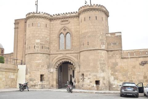       Historic fortified gate with rounded towers at Cairo Citadel.
  