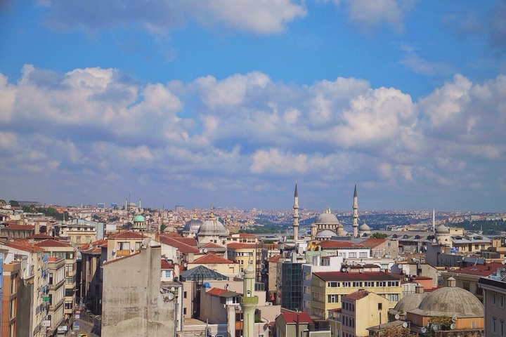       Cityscape of Istanbul with mosques and blue sky.
  