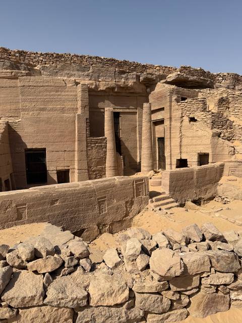       Weathered stone columns and walls of an ancient archaeological dig site.
  