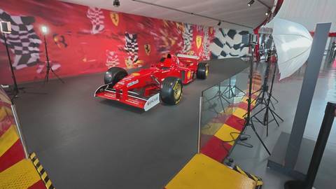       Exhibition of a red Formula-1 Ferrari race car inside Ferrari World theme park.
  