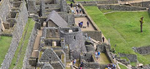       Elevated view of Machu Picchu’s stone dwellings and terraces packed with visitors
  