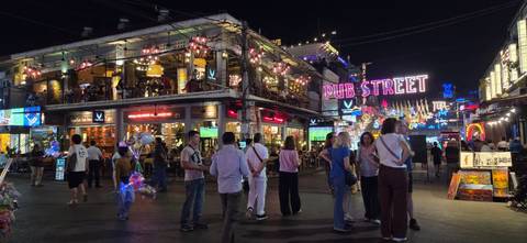       Siem Reap's lively Pub Street illuminated with neon signs and evening crowds.
  