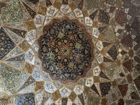       Intricate floral and geometric ceiling artwork with rich blues and golds.
  