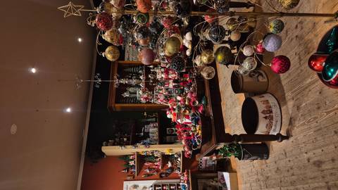       Cozy indoor Christmas shop filled with colorful ornaments and festive displays
  