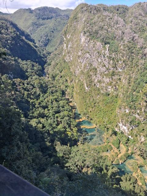       Aerial view of turquoise stepped pools deep in the Semuc Champey jungle canyon.
  