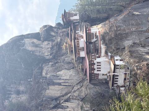       Iconic Tiger’s Nest Monastery clinging to a dramatic cliff face high above the Paro Valley.
  