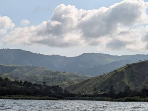       Rolling green mountain landscape under partly cloudy skies.
  