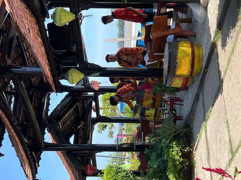       Traditional drummers perform under a wooden pavilion decorated with lanterns.
  