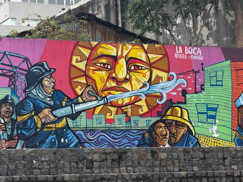       Colourful La Boca street art depicting firefighters spraying water toward a radiant sun motif.
  