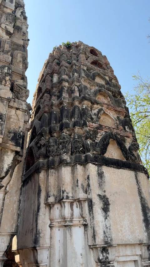       Detailed stucco and elephant reliefs on an ancient tower at Si Satchanalai Historical Park.
  