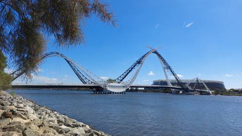       The sweeping arches of Matagarup Bridge span the Swan River beneath a clear blue sky.
  