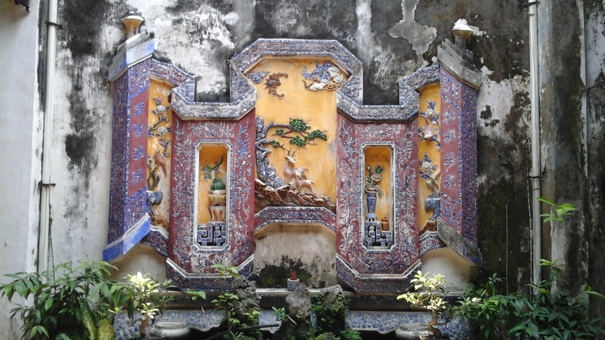       Colorful ornamental wall piece with botanical designs.
  