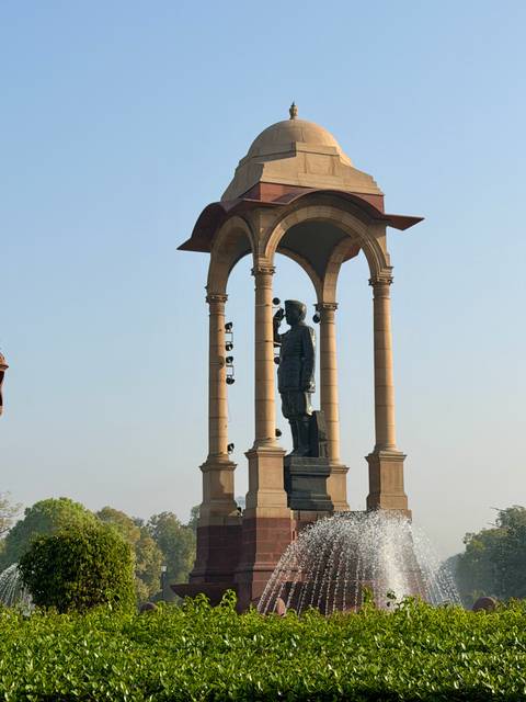       Statue beneath ornate sandstone canopy monument on Rajpath, New Delhi
  