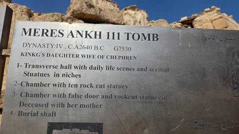       Metal information plaque describing the Meres Ankh III tomb with ruins blurred behind
  