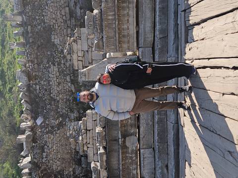       Travelling pair stand amid ancient marble ruins at Ephesus.
  