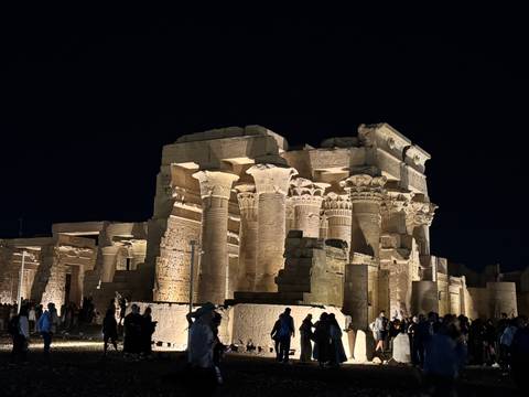       Nighttime crowds admire the dramatically lit columns of Kom Ombo Temple.
  