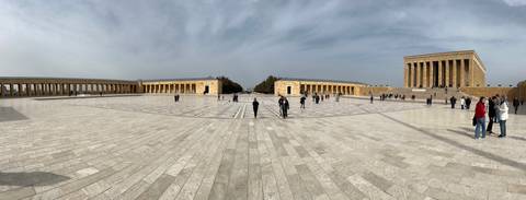       Wide marble plaza of Anıtkabir mausoleum complex with visitors scattered across the expansive square.
  