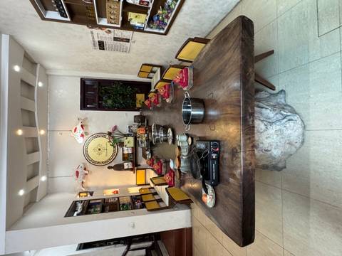       Long rustic table set with bowls, burners and ingredients prepared for a group cooking lesson.
  