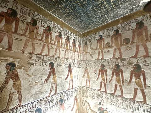       Colorful reliefs and hieroglyphs decorating the walls of an ancient Egyptian tomb chamber
  