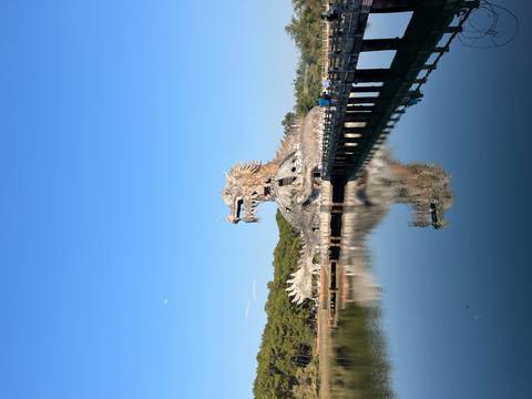       Dragon-shaped concrete structure rises from a reflective lake at Hue's abandoned water park
  